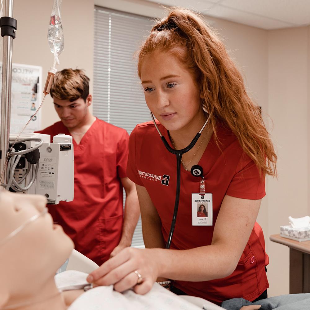 Nursing students working in a simulation lab